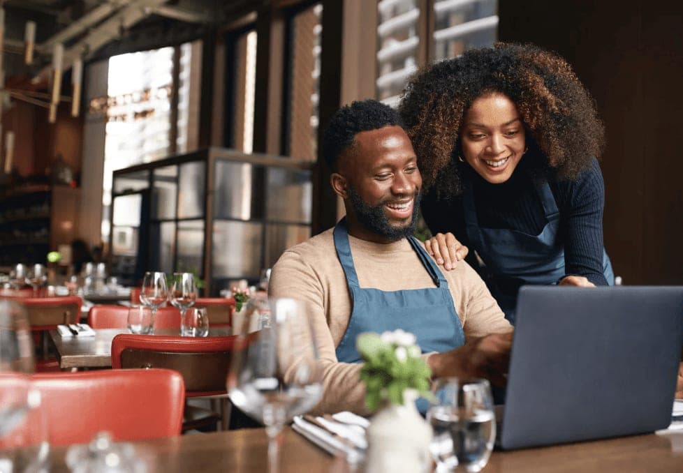 Restaurant owners reviewing catering orders