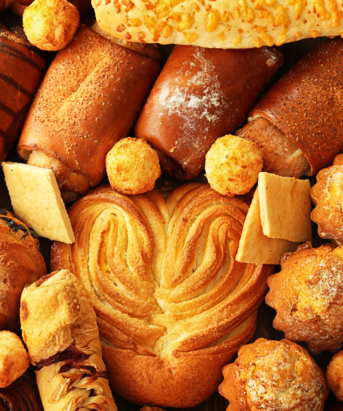 Assorted fresh baked pastries and bread with decorative patterns